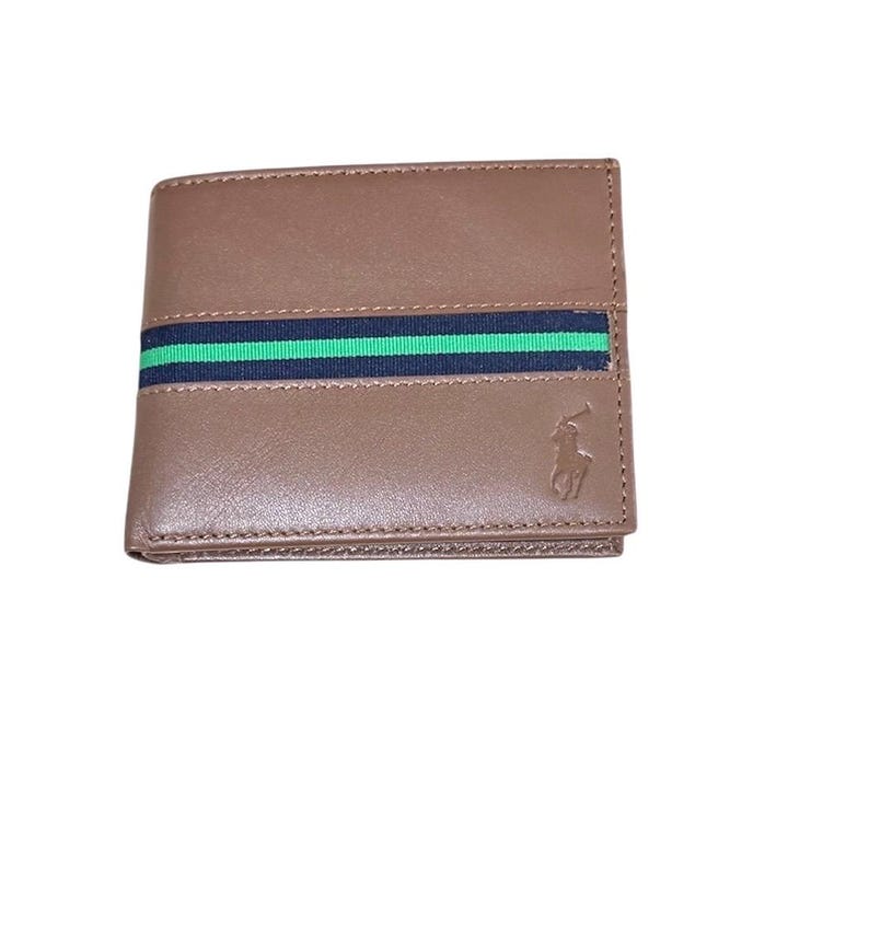 May include: A brown leather wallet with a green and black striped band and a polo player logo.