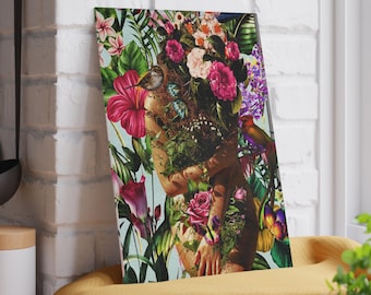 May include: A vibrant canvas print featuring a woman's form artfully integrated with lush floral and botanical elements. The artwork showcases a rich palette of pink, red, and green hues, with a bird perched amidst the flowers. The background is a soft blue.
