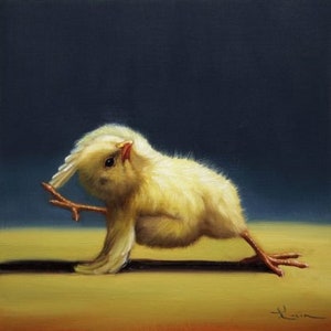 May include: A yellow baby chick with its wings spread out, performing a yoga pose on a light brown surface. The chick has a small beak and dark eyes.