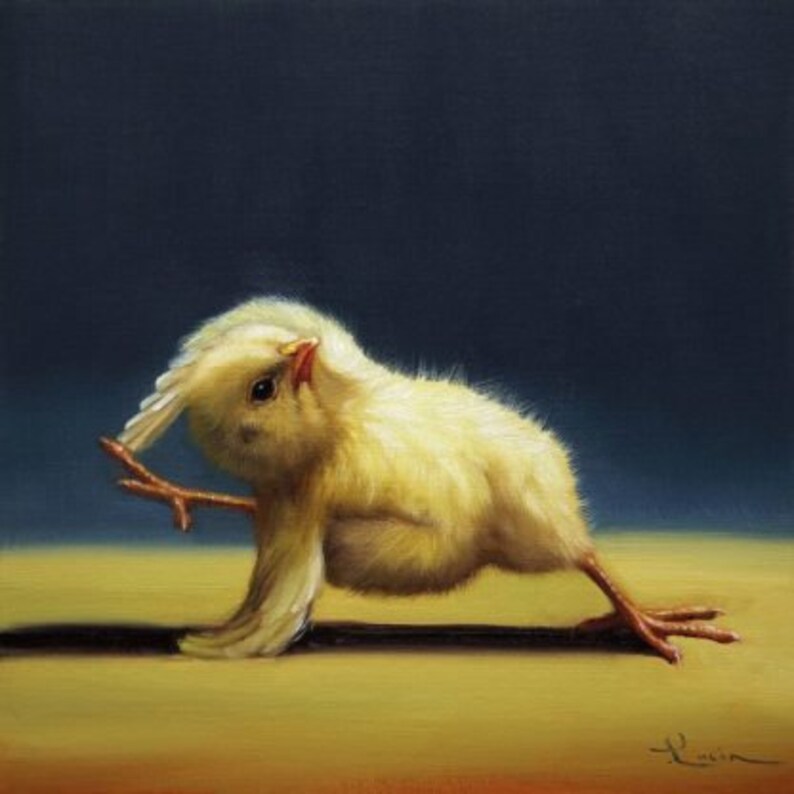 May include: A yellow baby chick with its wings spread out, performing a yoga pose on a light brown surface. The chick has a small beak and dark eyes.