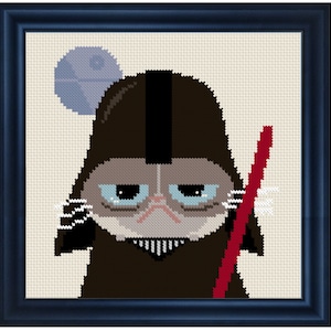 May include: A grumpy cat dressed as Darth Vader from Star Wars, holding a red lightsaber. The cat has a blue and white Death Star behind it.