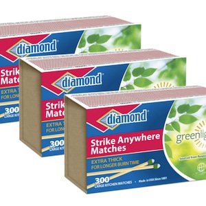 May include: Three boxes of Diamond Strike Anywhere Matches. Each box is brown with a red and blue label. The label reads "Strike Anywhere Matches" and "Extra Thick for Longer Burn Time". Each box contains 300 large kitchen matches.