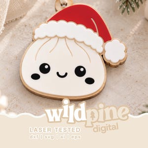 May include: A flat, wooden ornament shaped like a dumpling with a smiling face, wearing a red and white Santa hat. The design features a white dumpling body with black eyes and a mouth, topped with a red hat with white trim and a pom-pom.