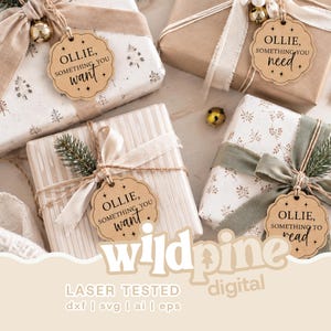 May include: Four gift-wrapped packages decorated with ribbons and greenery, each featuring a scalloped wooden gift tag. The tags are engraved with the text OLLIE, SOMETHING YOU WANT, OLLIE, SOMETHING YOU NEED, and OLLIE, SOMETHING YOU TO READ.