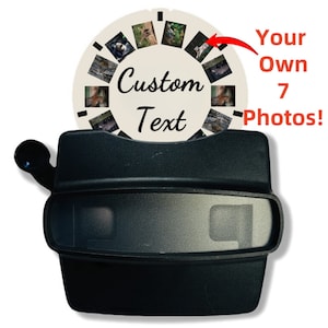 Op de afbeelding: Een zwarte vintage hand-crank viewer van plastic met een witte ronde dia met zeven afbeeldingen. De dia heeft de tekst "Custom Text" erop geschreven. De tekst "Your Own 7 Photos!" staat rechts in de afbeelding.