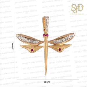 May include: A gold dragonfly pendant with clear gemstones and red accents. The pendant measures 30 mm in height and 28 mm in width.