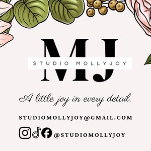 May include: A rectangular business card featuring a light pink background framed by illustrated pink and peach flowers with green leaves. The text reads MJ STUDIO MOLLYJOY, A little joy in every detail., STUDIOMOLLYJOY@GMAIL.COM, and @STUDIOMOLLYJOY.