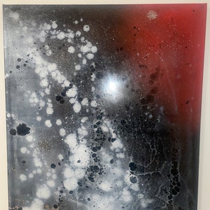 May include: Abstract painting with a black, white, and red color scheme. The painting features a large, white, splatter pattern on a black background. The right side of the painting is a solid red color.