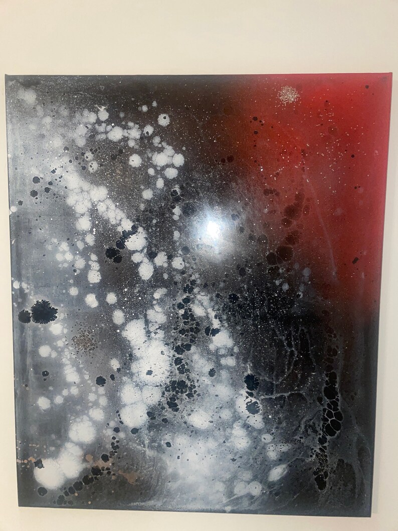 May include: Abstract painting with a black, white, and red color scheme. The painting features a large, white, splatter pattern on a black background. The right side of the painting is a solid red color.