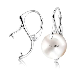 May include: Silver clip-on earrings with a white pearl measuring 12 mm in diameter.