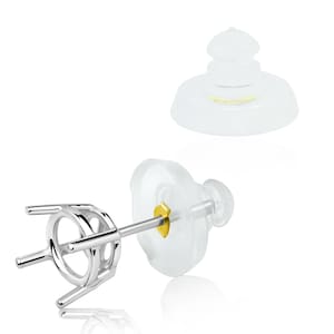 May include: A silver-colored earring post with a four-prong setting, a gold-colored post, and a clear, rounded earring back. A second clear earring back is also shown. The earring components are displayed against a white background.