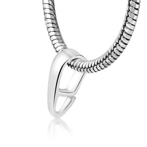 May include: Silver pendant bail with a teardrop shape and a secure clasp. The bail is designed to attach a pendant to a chain or necklace.