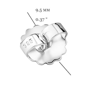 May include: Silver earring back with a 9.5 mm diameter, marked "925" for sterling silver.