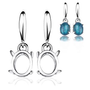 May include: Silver-toned earrings with a unique design. The earrings feature a loop at the top, a circular frame, and small decorative elements. Two pairs are shown, one with blue oval gemstones. The earrings are displayed against a white background.