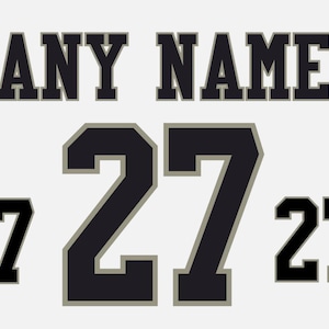 May include: A white background featuring the text "ANY NAME" in a black, blocky font. Below, a large number "27" is centered, with smaller "27"s on either side. The numbers are black with a grey outline.