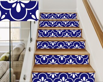 May include: Wooden staircase with blue and white patterned tile risers. The tile design features a repeating floral motif. The stairs have a wooden handrail and are set against a white wall and glass panel.