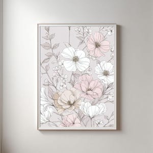 May include: A framed floral art print featuring a delicate arrangement of white, pink, and beige flowers. The artwork has a soft, pastel color palette and a detailed line drawing style, creating a serene and elegant aesthetic. The print is displayed on a light gray background.