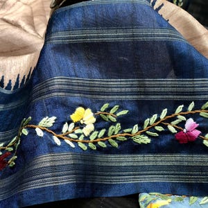 Handcrafted Tussar silk saree featuring delicate French knot embroidery with intricate floral detailing, offering a blend of texture, elegance, and artisanal charm.