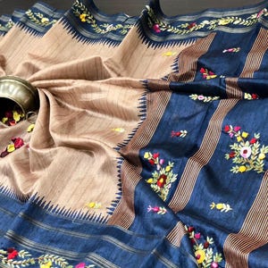 Handcrafted Tussar silk saree featuring delicate French knot embroidery with intricate floral detailing, offering a blend of texture, elegance, and artisanal charm.