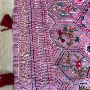 Pink Tussar silk saree featuring intricate Lambani and Kantha floral embroidery, elegant handcrafted ethnic saree with matching blouse piece, perfect for weddings, parties, festive occasions, and traditional celebrations.