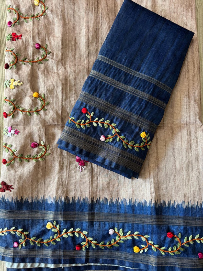 Handcrafted Tussar silk saree featuring delicate French knot embroidery with intricate floral detailing, offering a blend of texture, elegance, and artisanal charm.