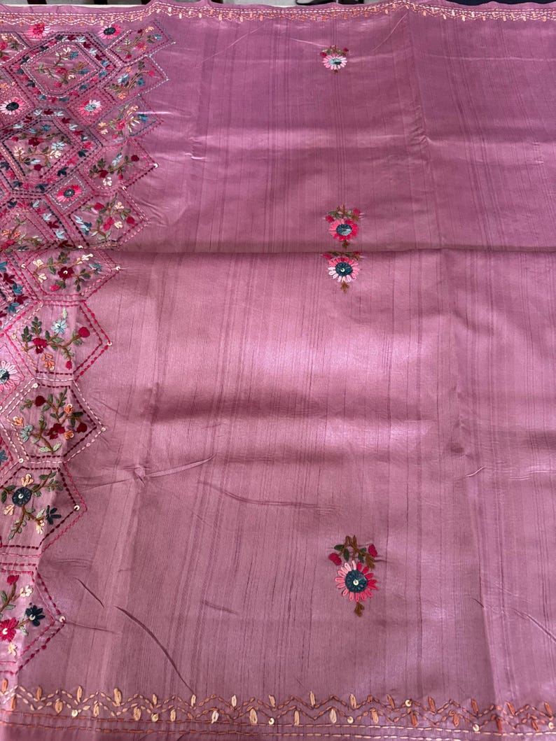 Pink Tussar silk saree featuring intricate Lambani and Kantha floral embroidery, elegant handcrafted ethnic saree with matching blouse piece, perfect for weddings, parties, festive occasions, and traditional celebrations.