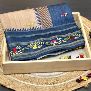 Handcrafted Tussar silk saree featuring delicate French knot embroidery with intricate floral detailing, offering a blend of texture, elegance, and artisanal charm.