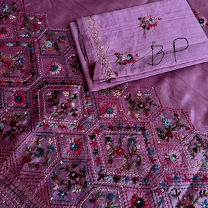 Pink Tussar silk saree featuring intricate Lambani and Kantha floral embroidery, elegant handcrafted ethnic saree with matching blouse piece, perfect for weddings, parties, festive occasions, and traditional celebrations.