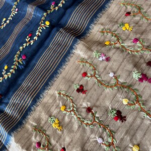 Handcrafted Tussar silk saree featuring delicate French knot embroidery with intricate floral detailing, offering a blend of texture, elegance, and artisanal charm.