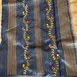 Handcrafted Tussar silk saree featuring delicate French knot embroidery with intricate floral detailing, offering a blend of texture, elegance, and artisanal charm.
