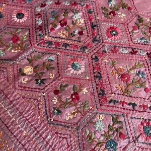 Pink Tussar silk saree featuring intricate Lambani and Kantha floral embroidery, elegant handcrafted ethnic saree with matching blouse piece, perfect for weddings, parties, festive occasions, and traditional celebrations.