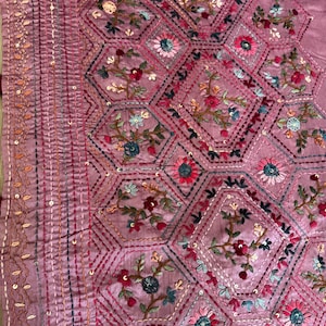 Pink Tussar silk saree featuring intricate Lambani and Kantha floral embroidery, elegant handcrafted ethnic saree with matching blouse piece, perfect for weddings, parties, festive occasions, and traditional celebrations.