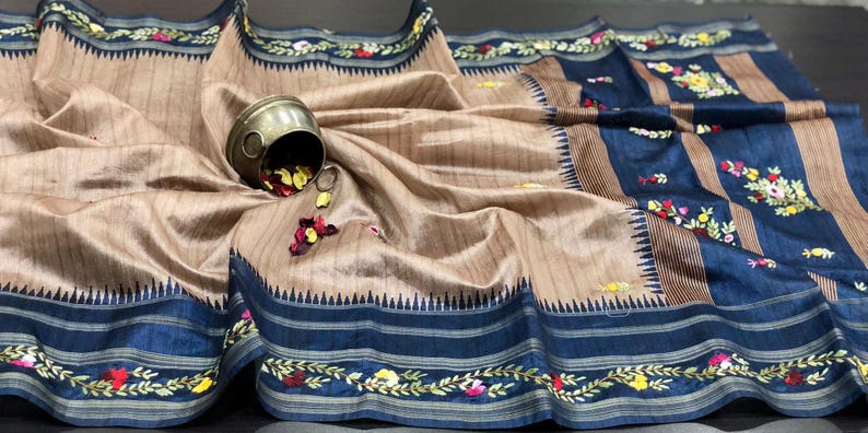 Handcrafted Tussar silk saree featuring delicate French knot embroidery with intricate floral detailing, offering a blend of texture, elegance, and artisanal charm.