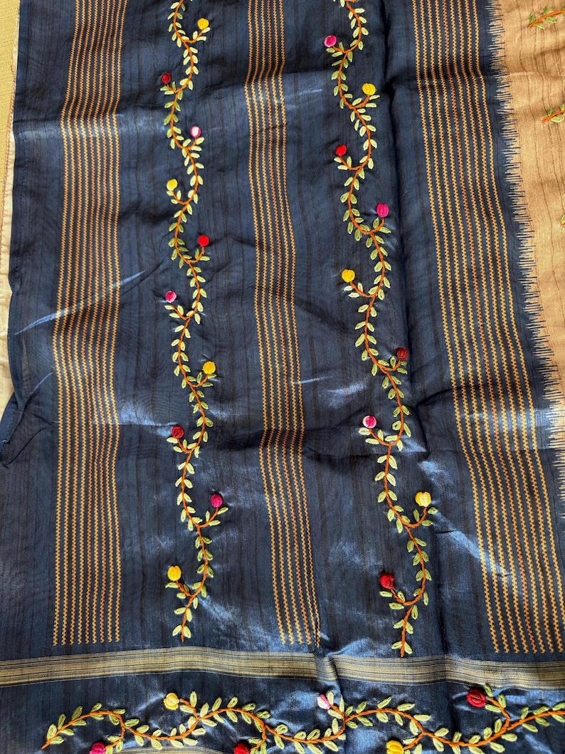 Handcrafted Tussar silk saree featuring delicate French knot embroidery with intricate floral detailing, offering a blend of texture, elegance, and artisanal charm.