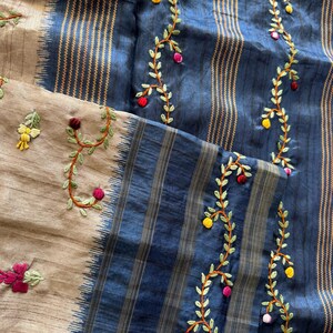 Handcrafted Tussar silk saree featuring delicate French knot embroidery with intricate floral detailing, offering a blend of texture, elegance, and artisanal charm.