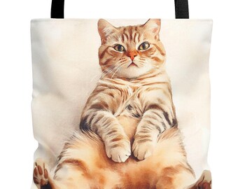 May include: A brown tabby cat with white markings sits on a white background. The cat has its paws crossed and is looking directly at the camera.