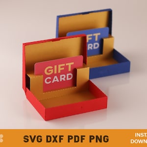 May include: Two gift card boxes, one red and one blue, with a gold interior. The boxes are open and show the gift card slots. The red box has a gift card that says "Gift Card" in a red and white font. The blue box has a gift card that says "Gift Card" in a white font.