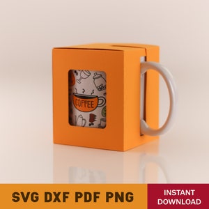 May include: Orange mug box with a white mug inside. The mug has a black and white design with the word "COFFEE" on it.