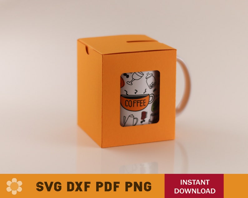 May include: Orange cardboard box with a cut-out window showing a white mug with a black and white coffee themed design. The mug has the word "COFFEE" printed on it.