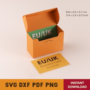 May include: Orange business card holder with a green business card inside. The card holder is open and the business card is visible. The business card says "EU/UK Business Card 85/55mm".