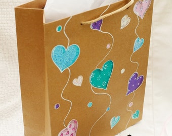 Gift bag, medium size, hand drawn. Multicoloured hearts on brown kraft paper. Original drawings, not printed.