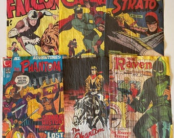 Puede incluir: Un collage de portadas de cómics vintage con personajes como The Phantom, Captain Strato, The Raven y Catman. Las portadas son de varios tonos de rojo, azul, verde y amarillo con texto negro e ilustraciones.