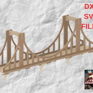 May include: A wooden model of a suspension bridge, with a brown finish. The bridge is designed to be assembled and is available as a digital download in DXF and SVG file formats. The image includes the text "DXF SVG FILES".