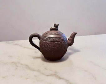 Chinese Clay Teapot with cat on lid and Incised Floral Design.