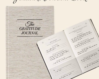 May include: A closed brown linen-textured journal with the title "The Gratitude Journal" printed on the front cover. The open journal pages feature a weekly gratitude challenge with prompts for reflection and appreciation.