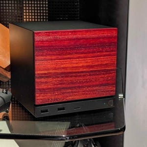 A solid wood padauk faceplate for the 2026 Steam Machine, made from genuine wood.