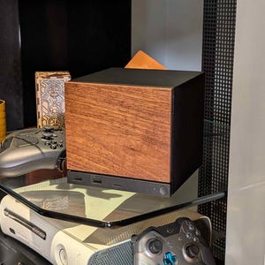 A solid wood walnut faceplate for the 2026 Steam Machine, made from genuine wood.