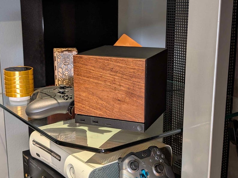 A solid wood walnut faceplate for the 2026 Steam Machine, made from genuine wood.