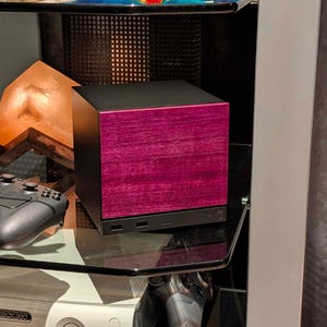 A solid wood purpleheart faceplate for the 2026 Steam Machine, made from genuine wood.