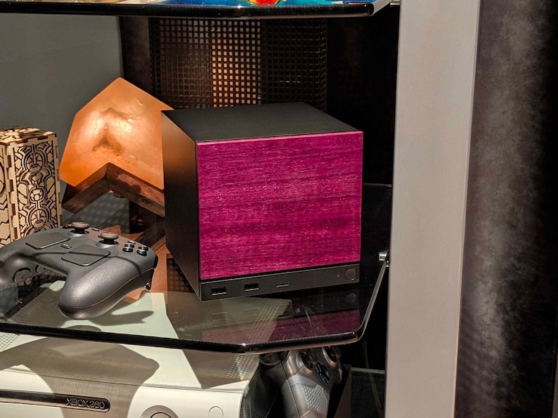A solid wood purpleheart faceplate for the 2026 Steam Machine, made from genuine wood.